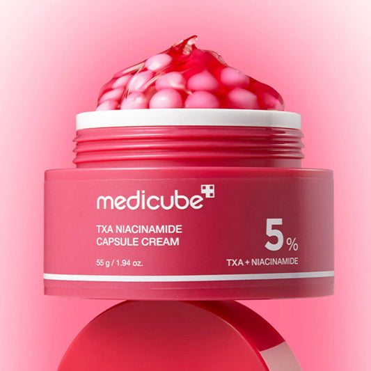 Red jar of Medicube TXA Niacinamide Capsule Cream on a pink background